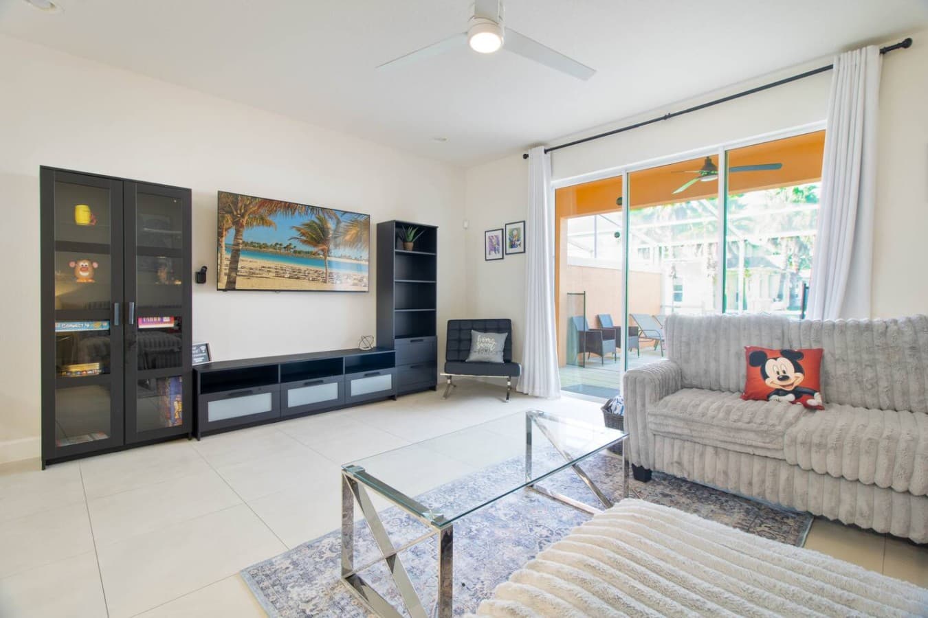 Stylish entertainment space featuring a sleek media console and patio access.