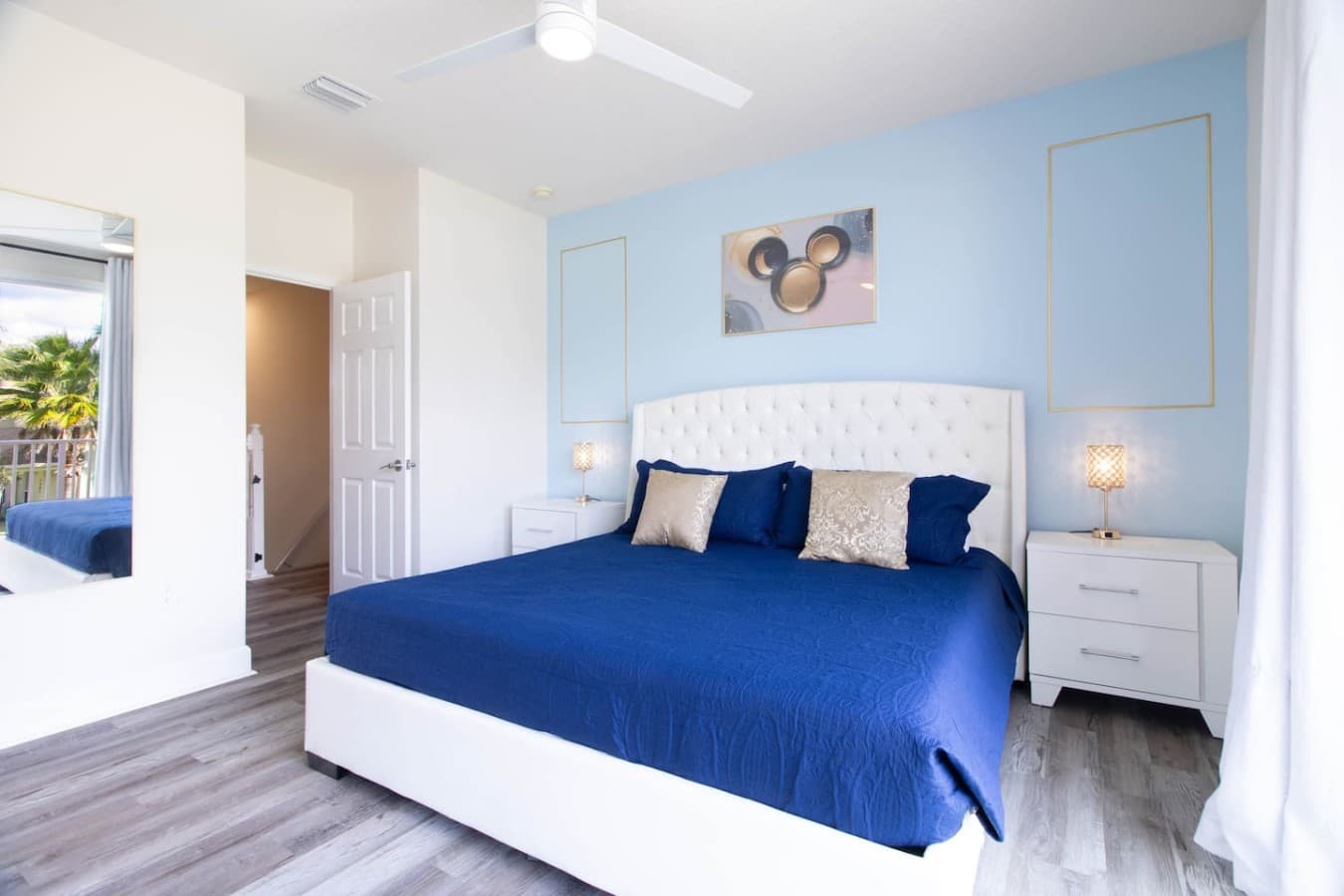 Spacious bedroom featuring a plush upholstered bed and calming color palette.