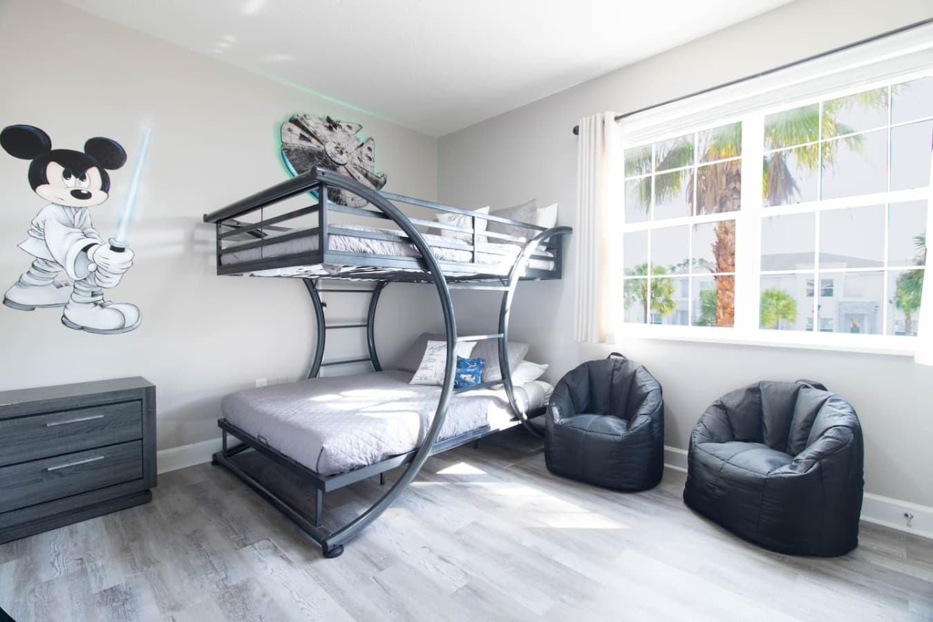 Fun bunk bedroom with space saving design and comfortable seating area.