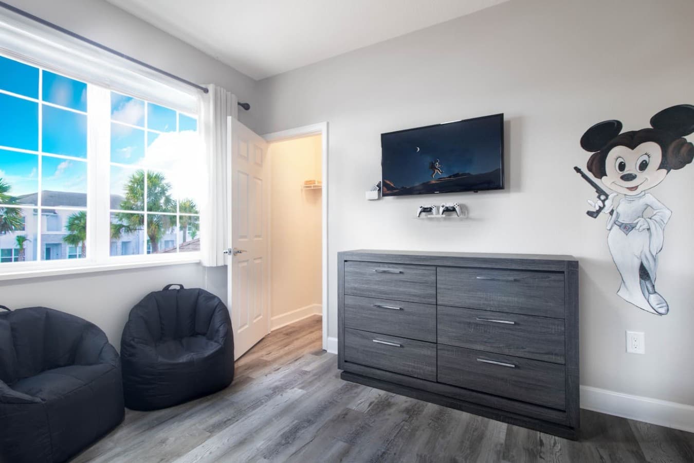 Bright guest bedroom featuring modern furnishings and abundant natural light.