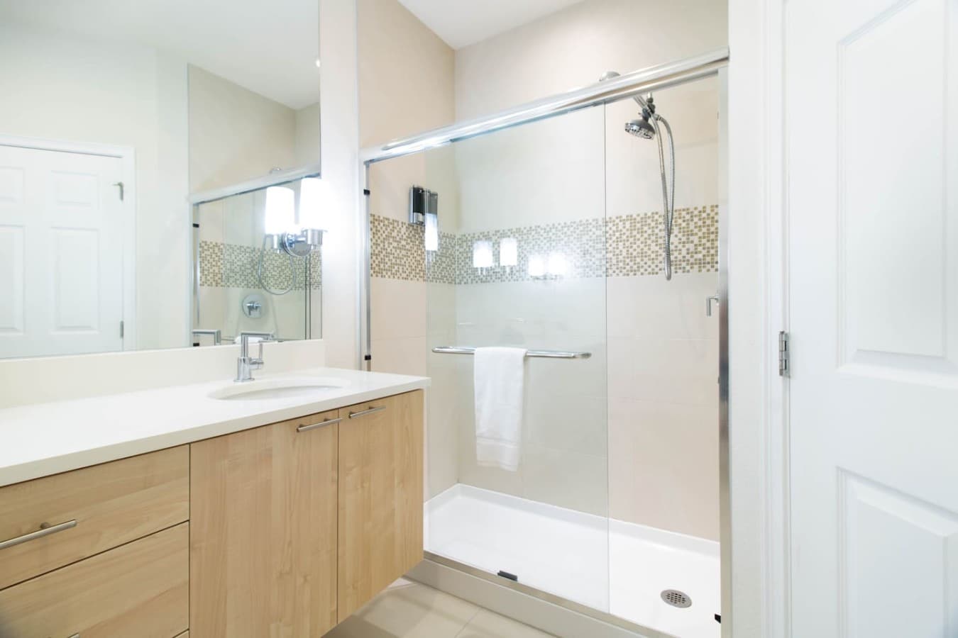 Modern bathroom with a sleek glass enclosed shower and contemporary finishes.