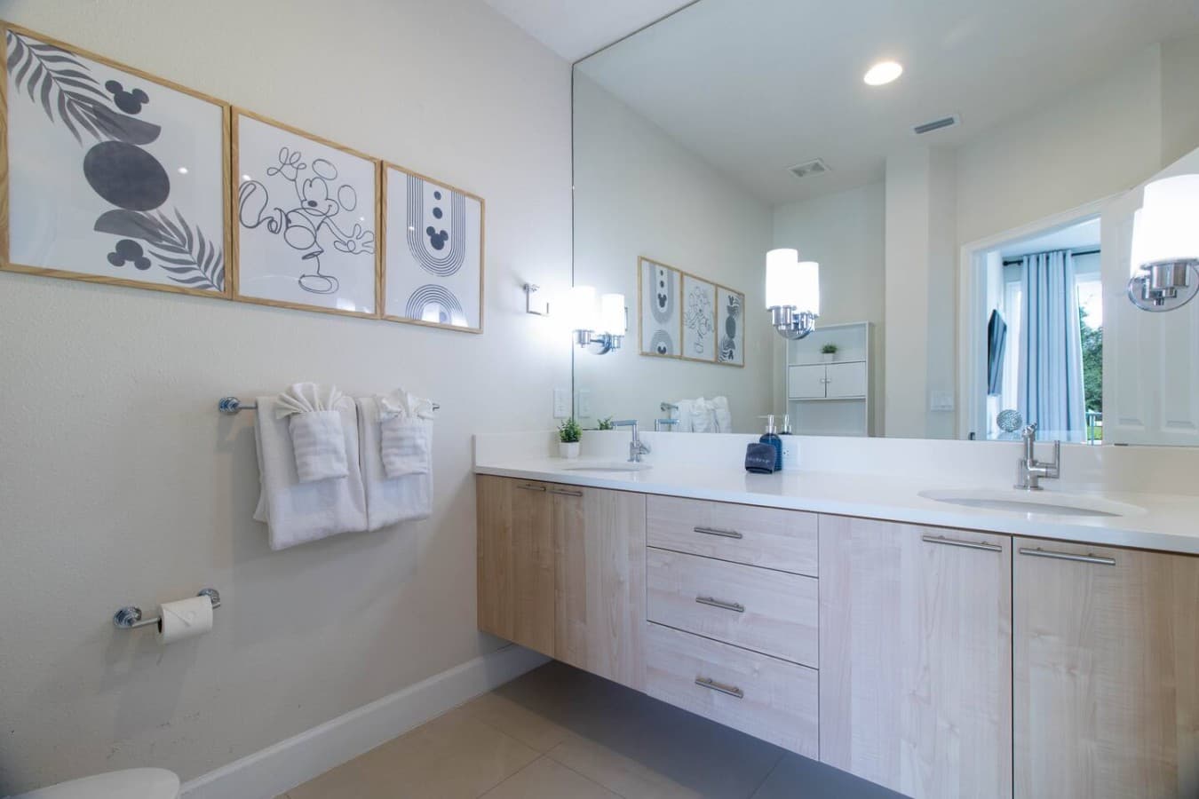 Spacious bathroom featuring dual vanities, ample counter space, and elegant decor.