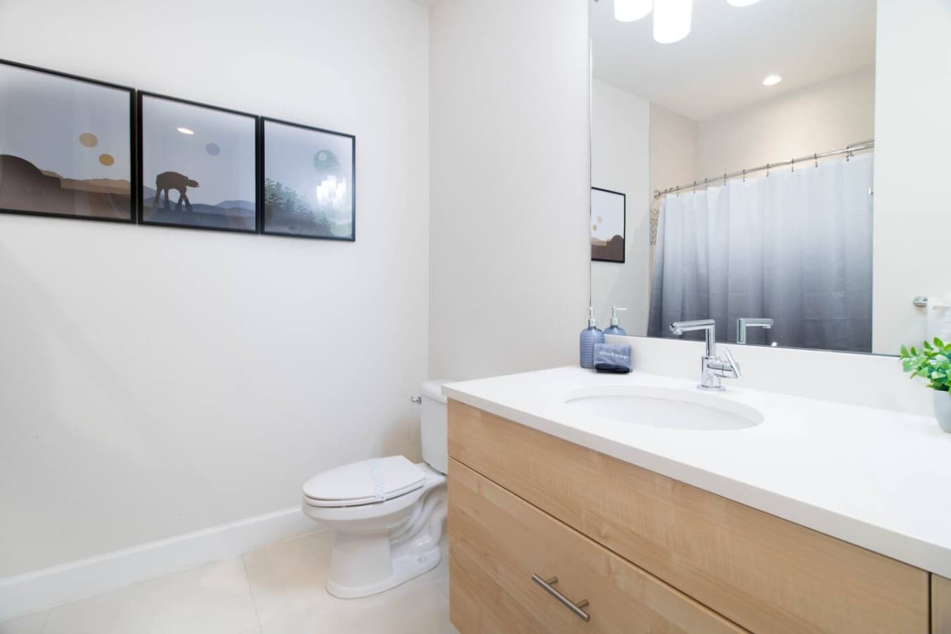 Bright and clean bathroom featuring a modern vanity with ample storage.