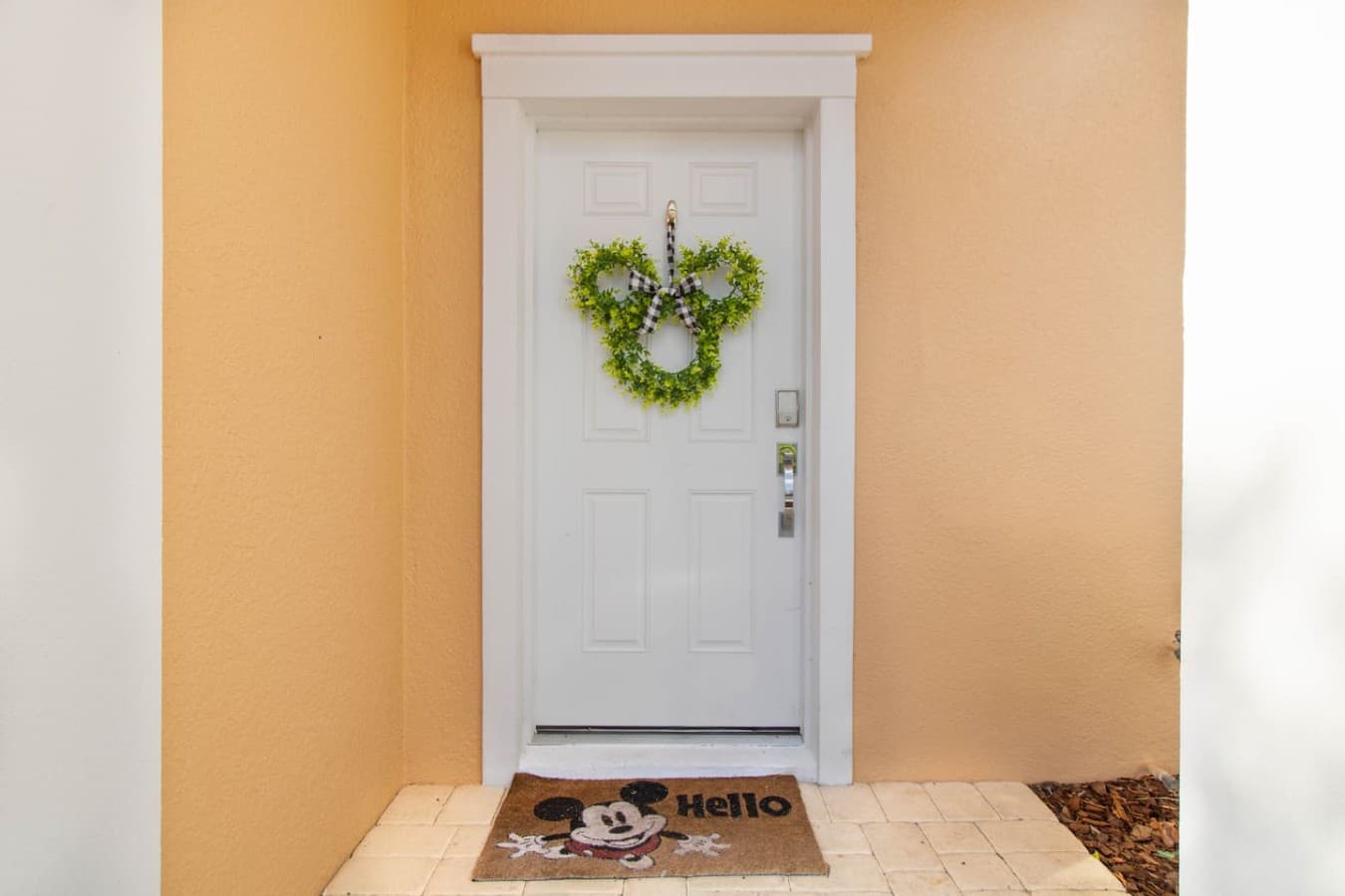 Inviting front entrance featuring charming decorative accents and covered access.