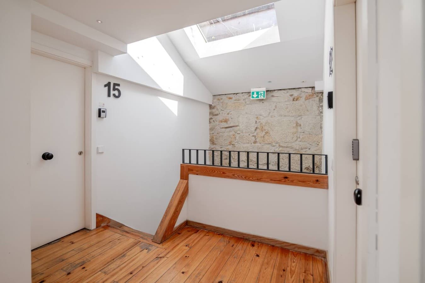 Bright and well-maintained exterior common hallway with natural light, modern finishes, and secure apartment access.