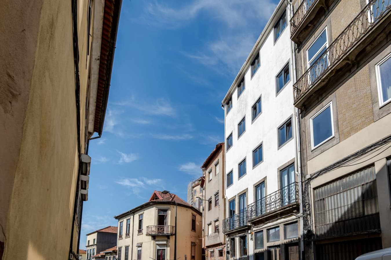 View of the building's façade showcasing its modern exterior set along a charming neighborhood street.