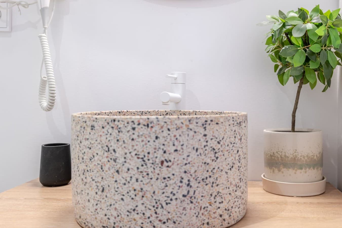 Contemporary bathroom vanity featuring a stylish terrazzo vessel sink and clean, modern finishes.
