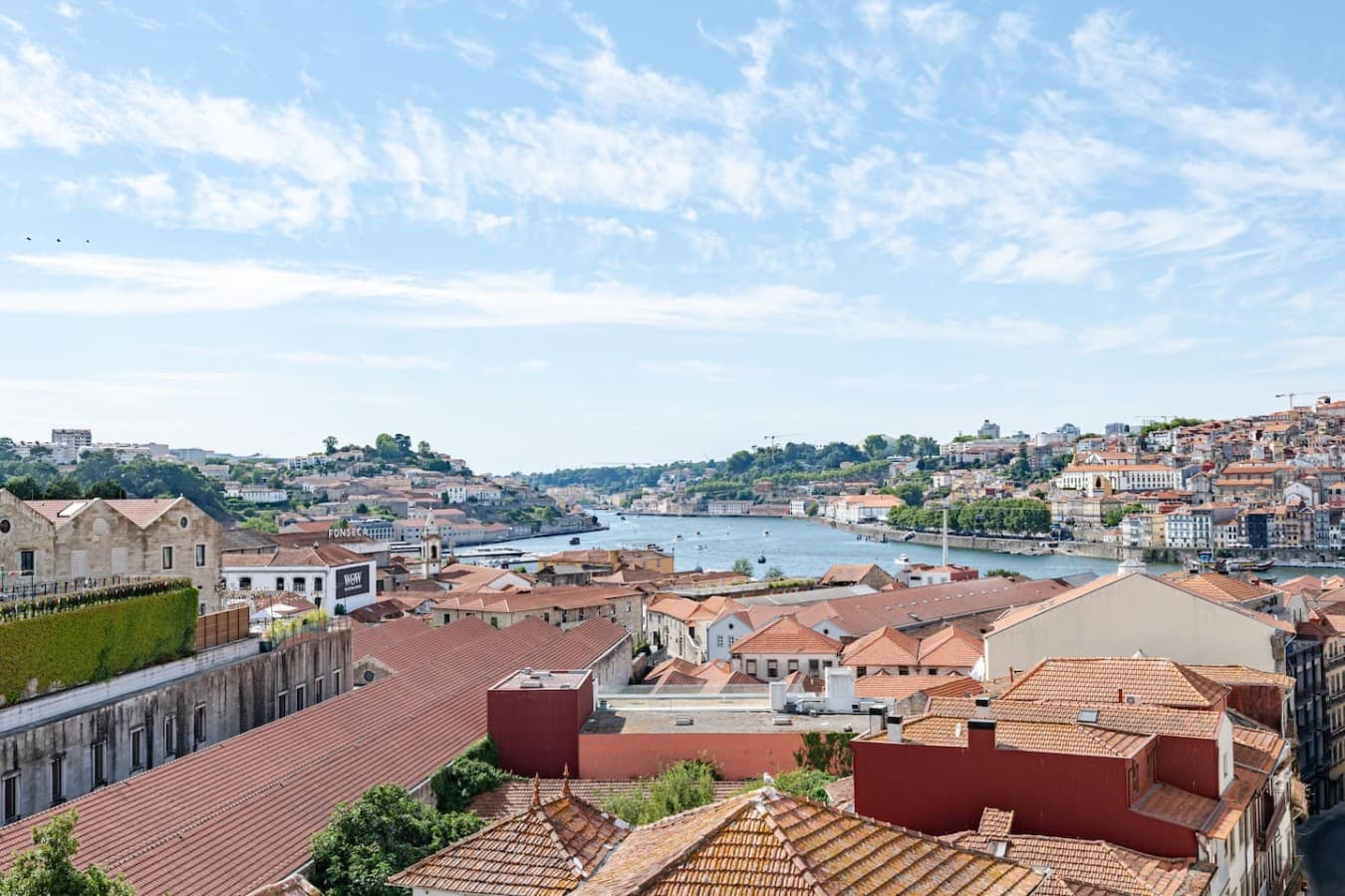 Sweeping panoramic views over the city skyline, terracotta rooftops, and the tranquil riverside.