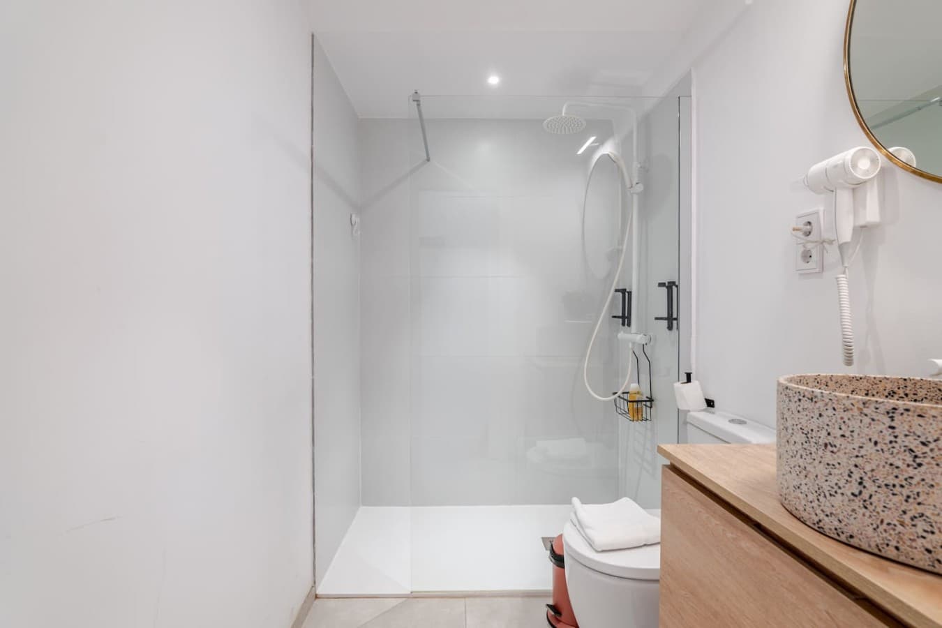 Refresh in the modern walk-in shower with a spacious, glass-enclosed design.