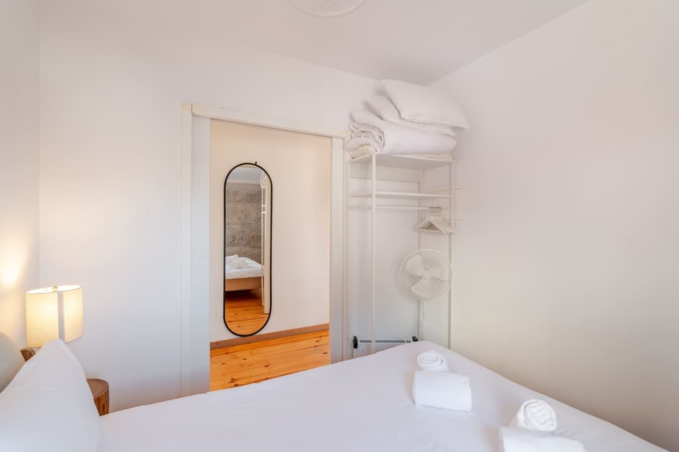 Open wardrobe space and a full-length mirror make unpacking easy.