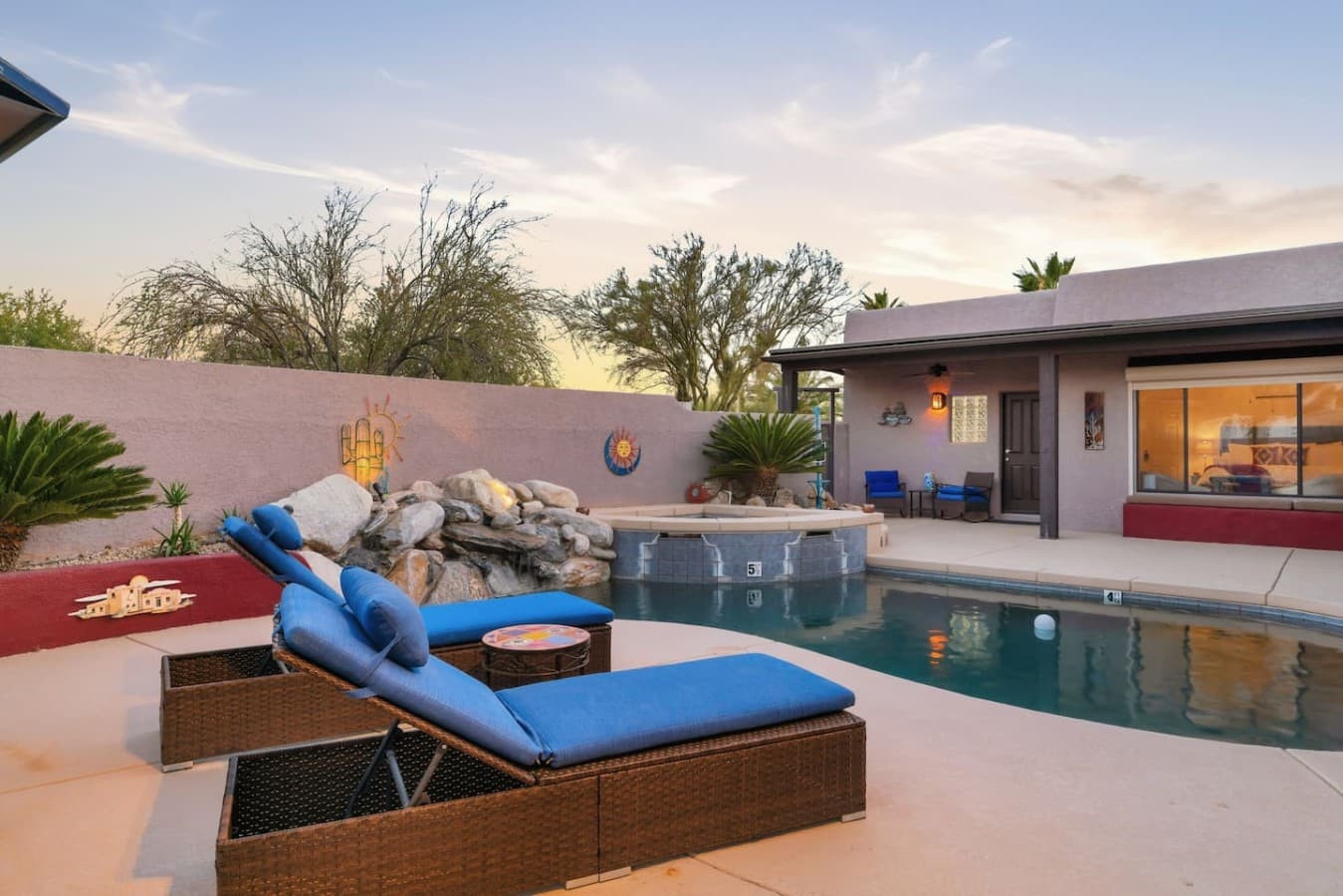 Resort style pool with lounge seating and relaxing outdoor space.