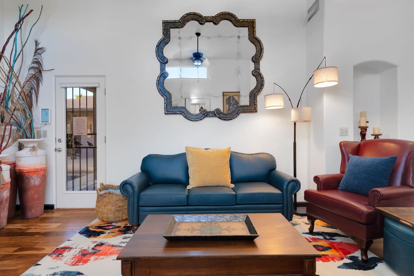 Comfortable seating area with modern decor and a statement mirror feature.