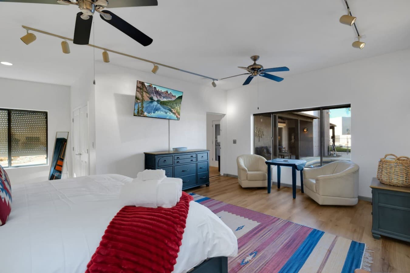Bright and open bedroom with comfortable furnishings and modern touches.