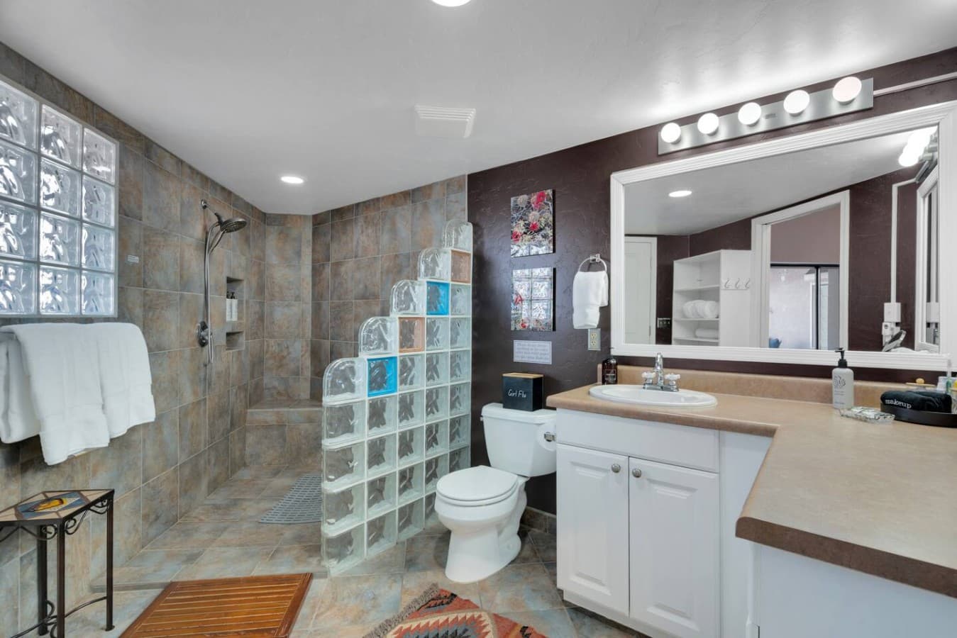 Spacious bathroom with modern vanity and walk in shower.