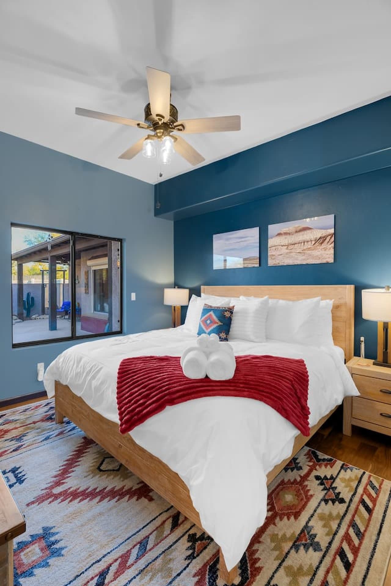 Inviting bedroom with plush bedding and calming blue walls.