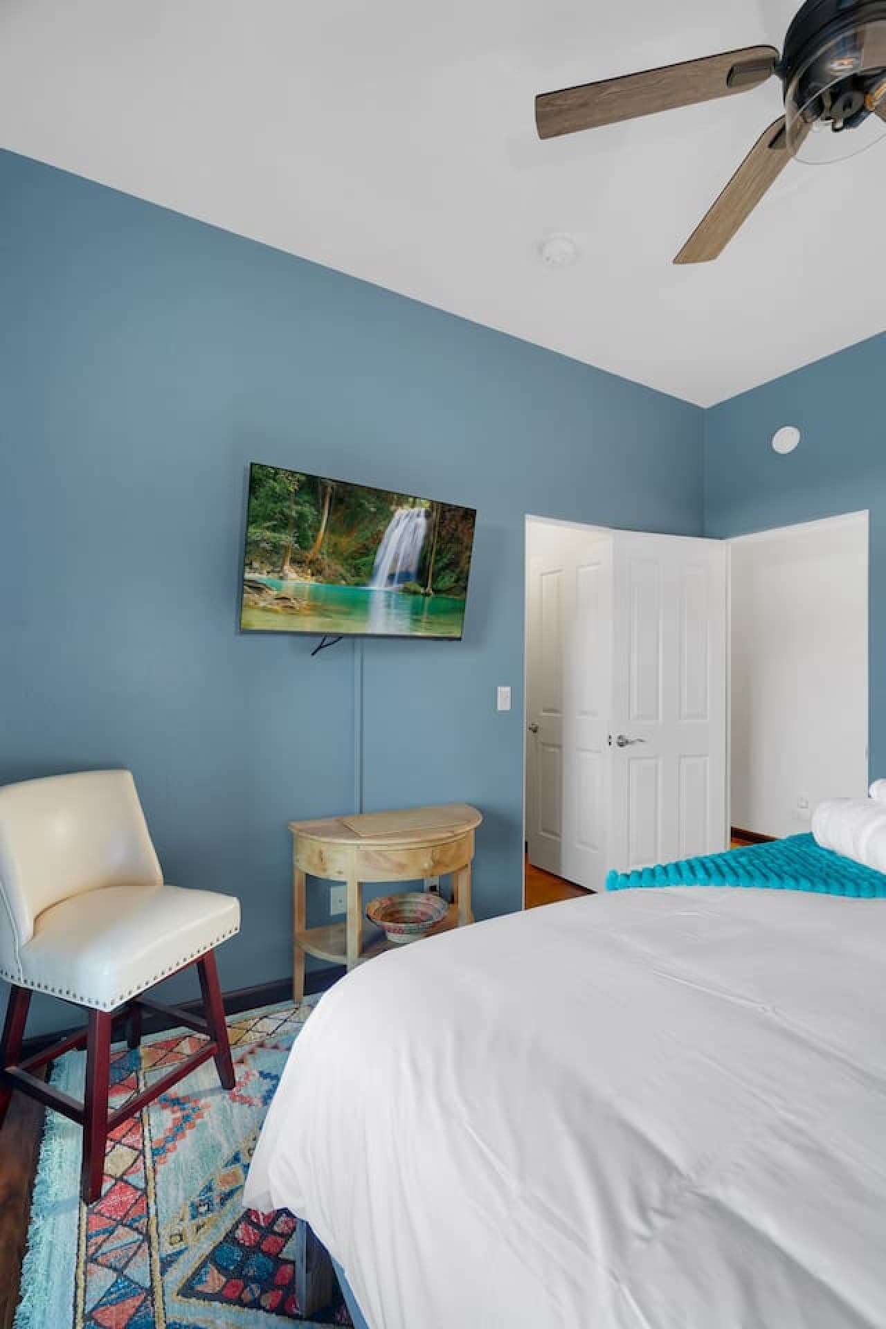 Comfortable bedroom with smart TV and a peaceful setting.