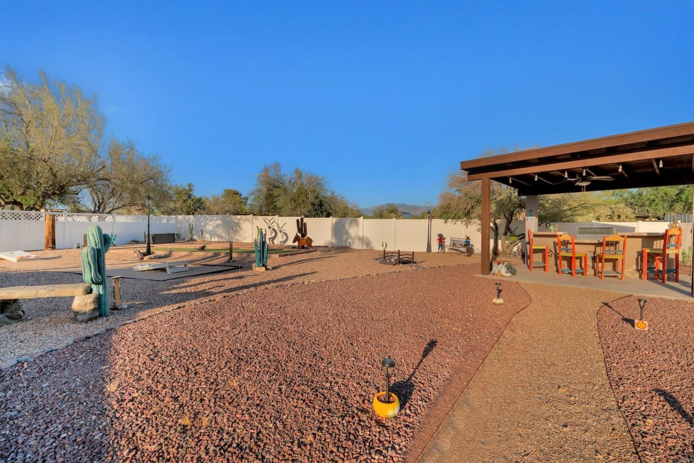 Expansive yard with desert landscaping and open space.