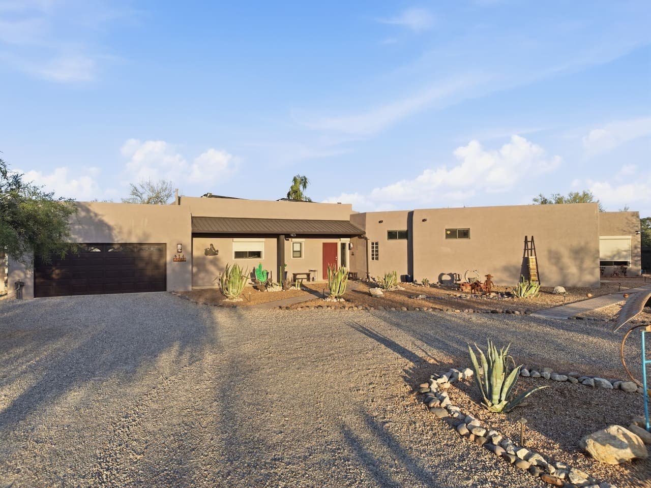 Wide driveway with plenty of parking and open surroundings.