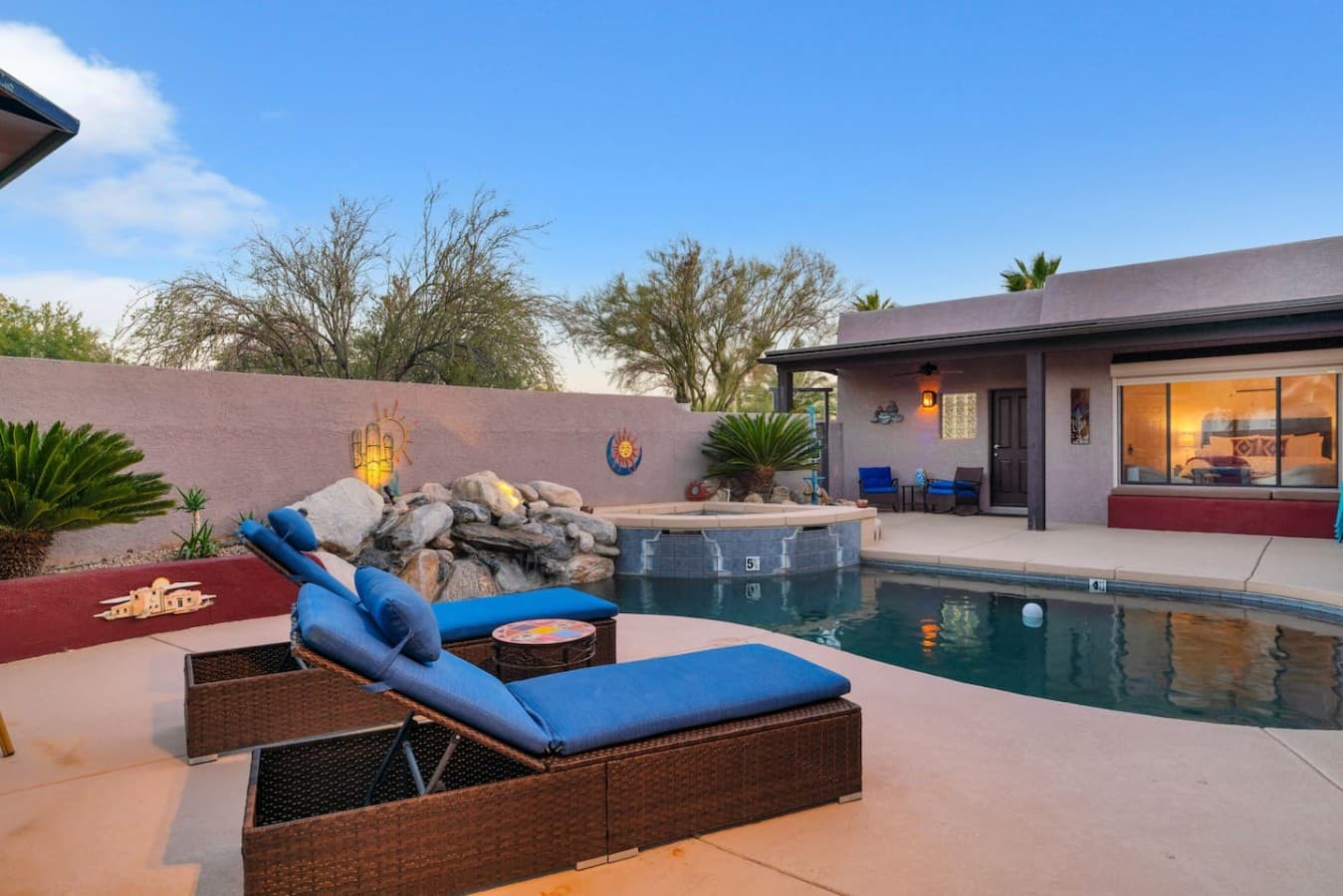 Resort style pool with lounge seating and relaxing outdoor space.