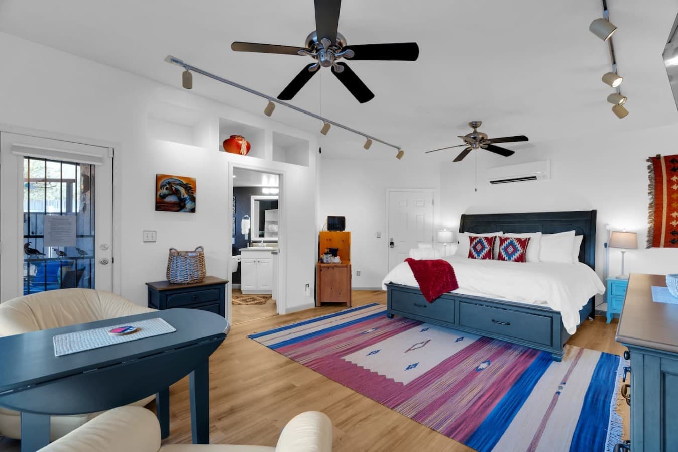 Spacious bedroom with colorful accents and plenty of natural light.