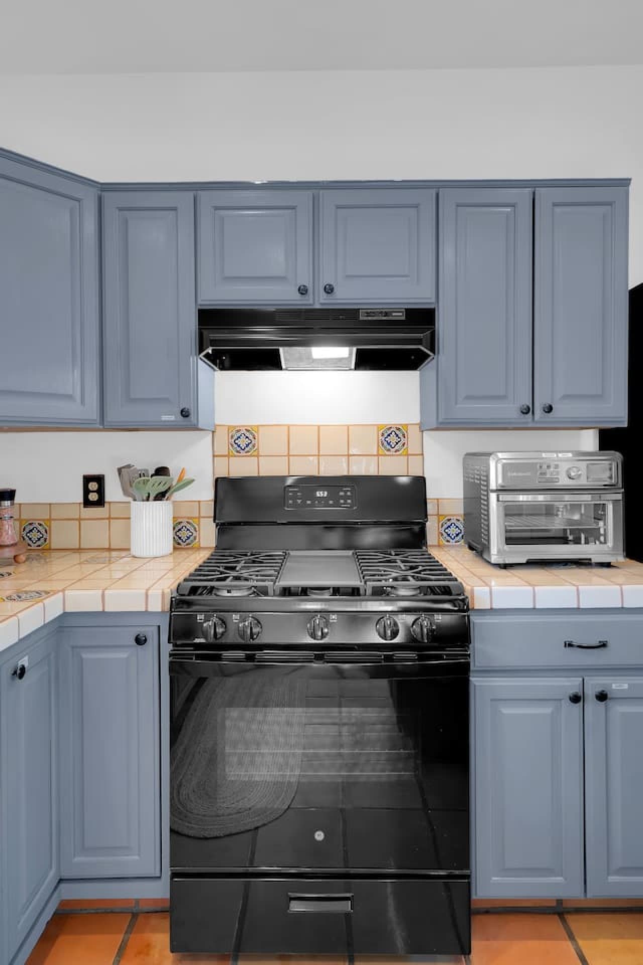 Gas range and cooking area perfect for preparing meals at home.