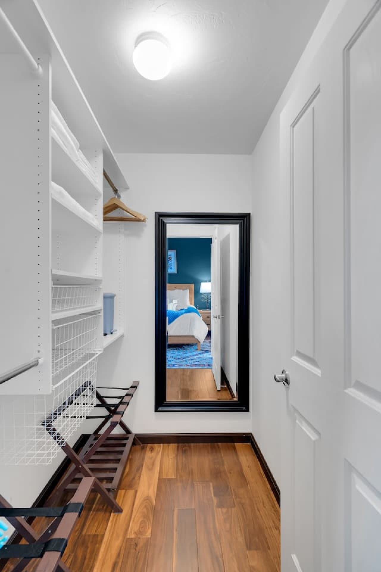 Walk in closet with ample storage and full length mirror.