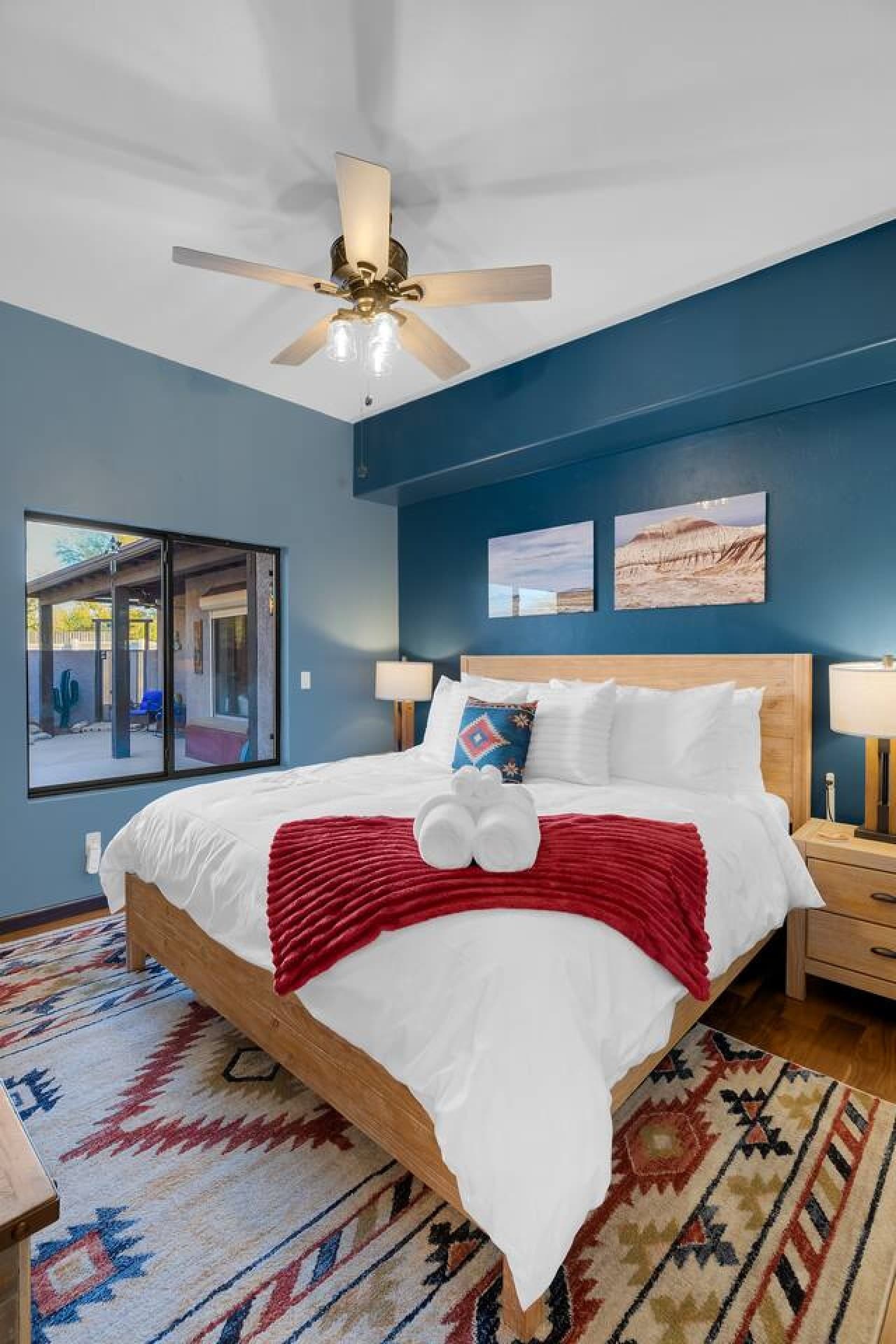 Inviting bedroom with plush bedding and calming blue walls.
