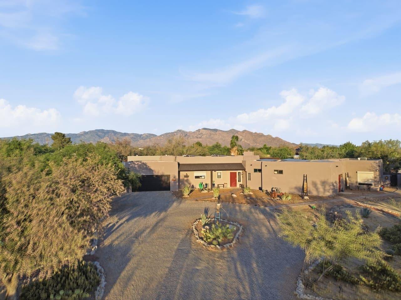 Wide driveway with plenty of parking and open surroundings.