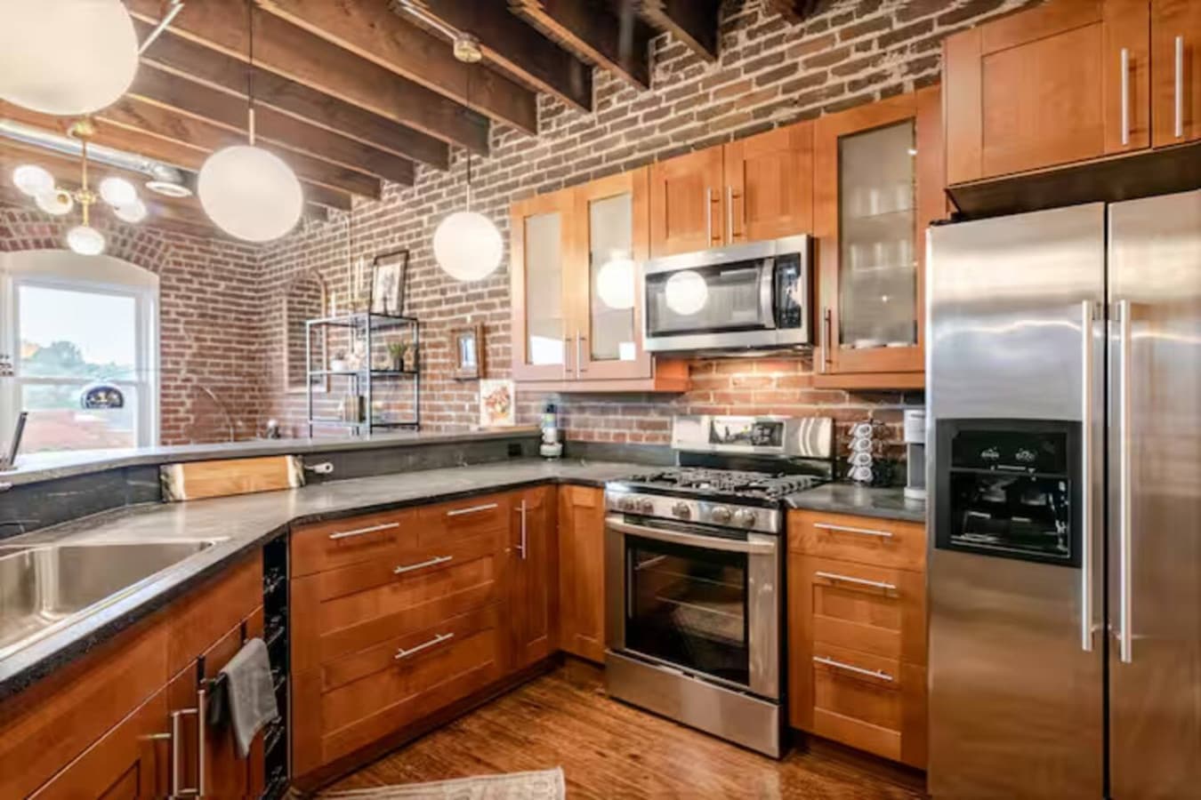 Fully equipped kitchen with stainless steel appliances and warm wood cabinetry.