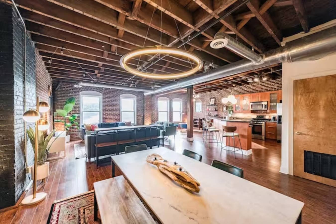 Bright open living space with modern lighting and loft style design.
