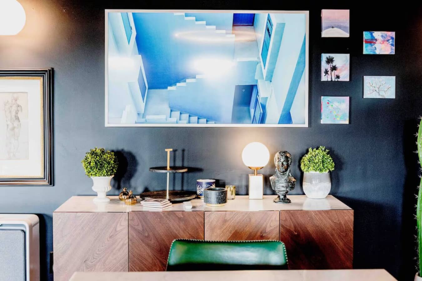 Styled console with artwork and soft lighting details.