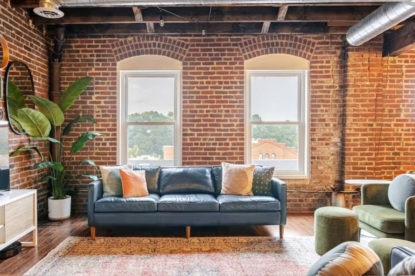 Living room with exposed brick and natural light.