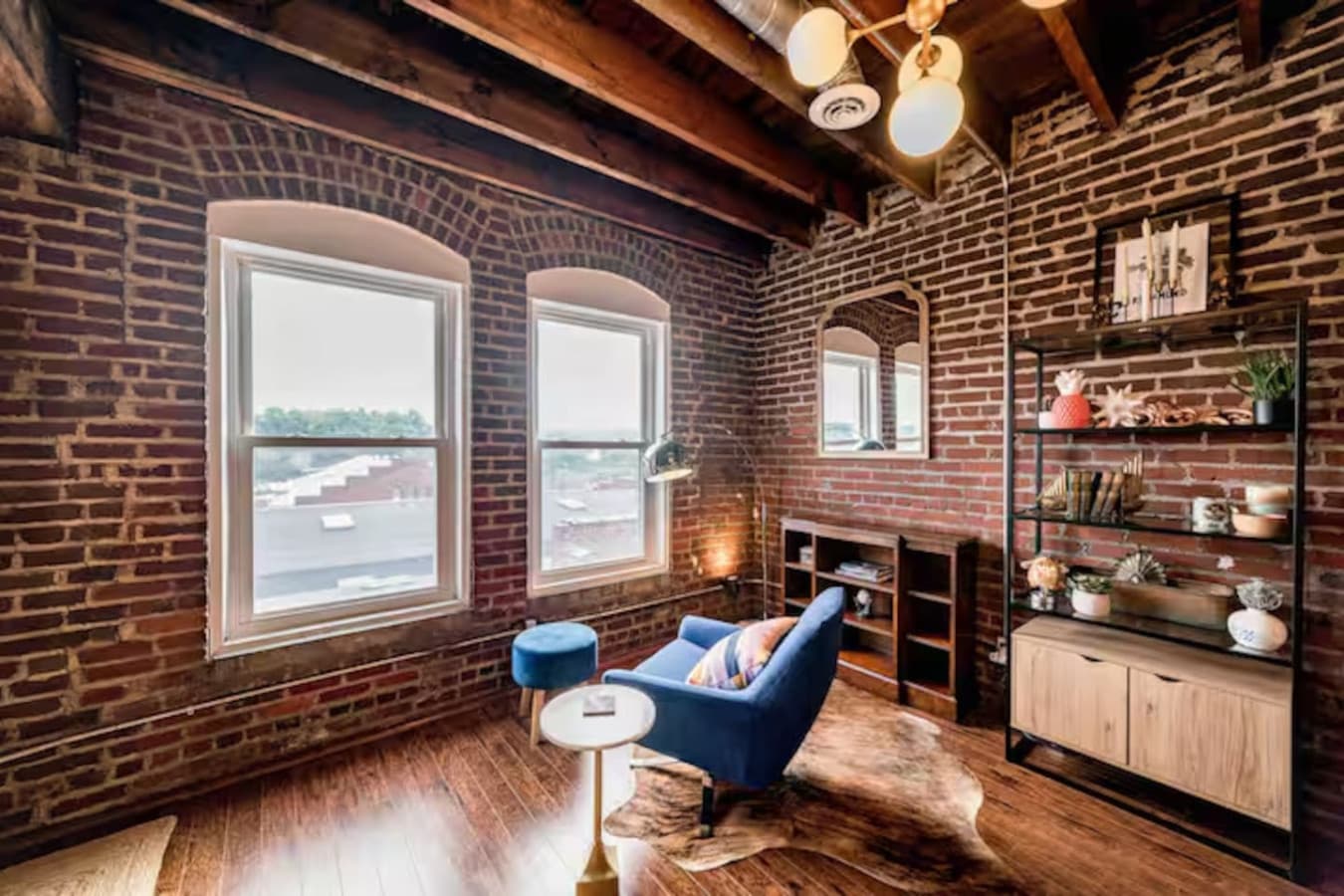 Quiet corner with lounge chair and city views through large windows.
