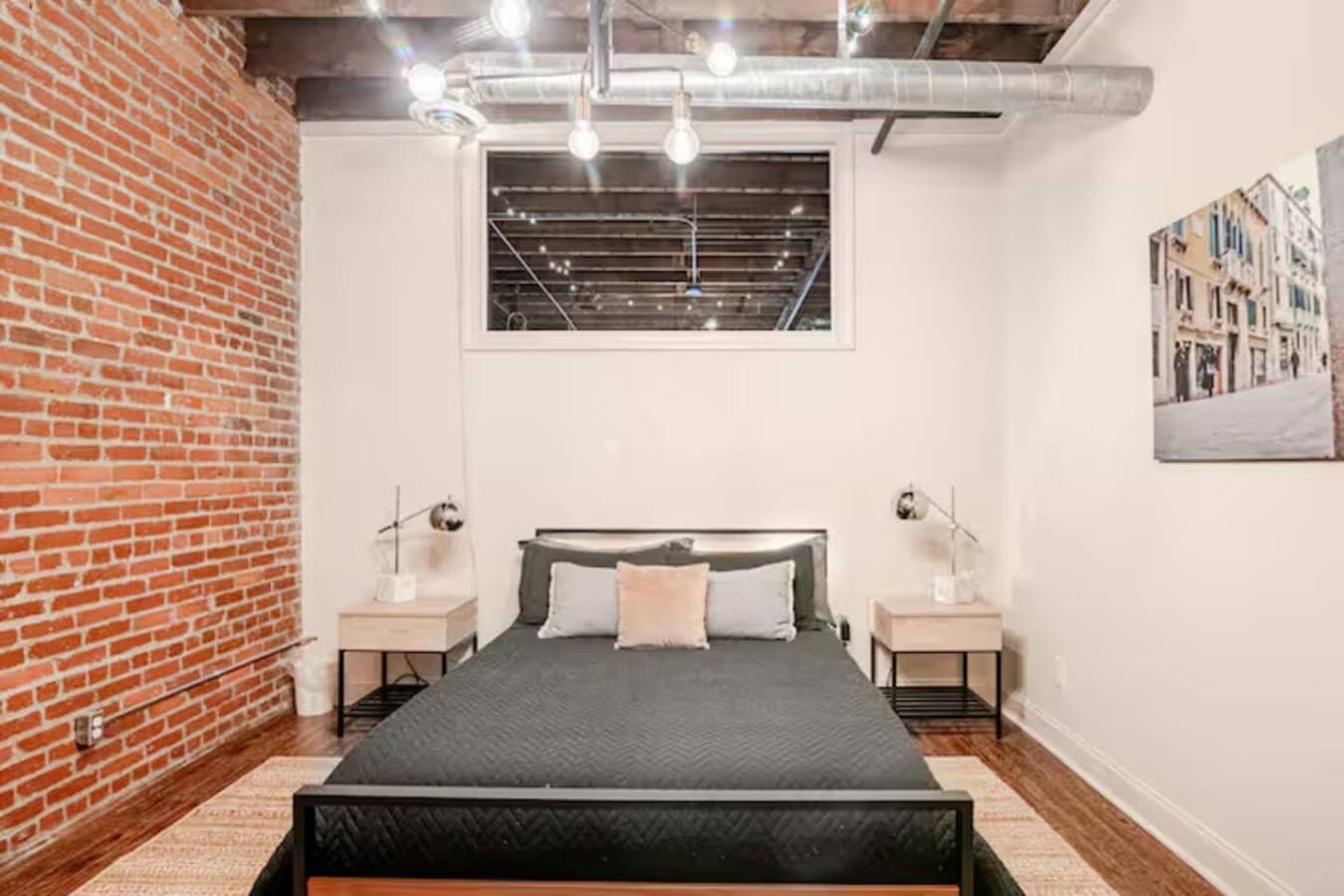 Minimalist bedroom with comfortable bed and soft lighting.