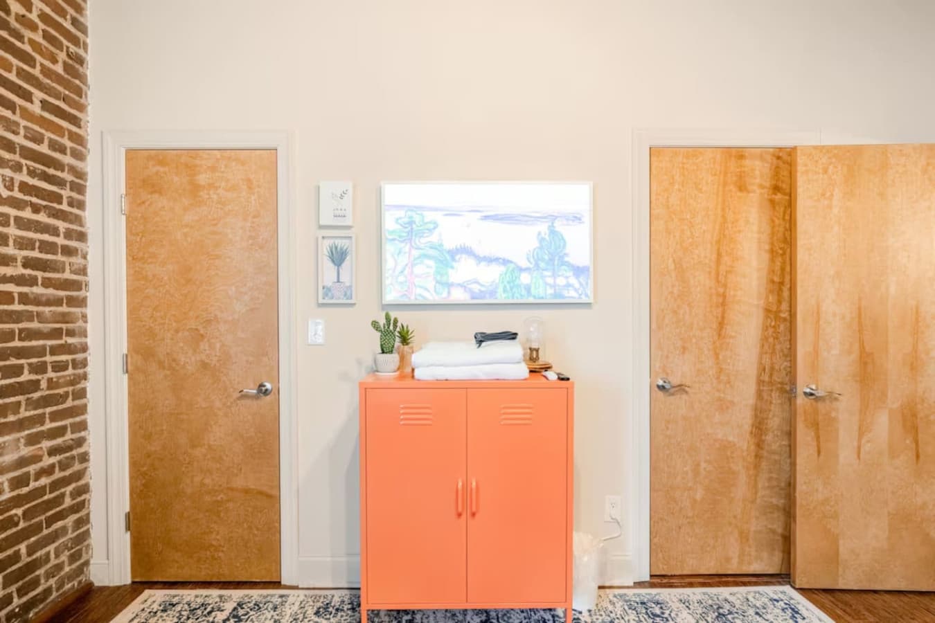 Entry area with accent cabinet and hallway access.