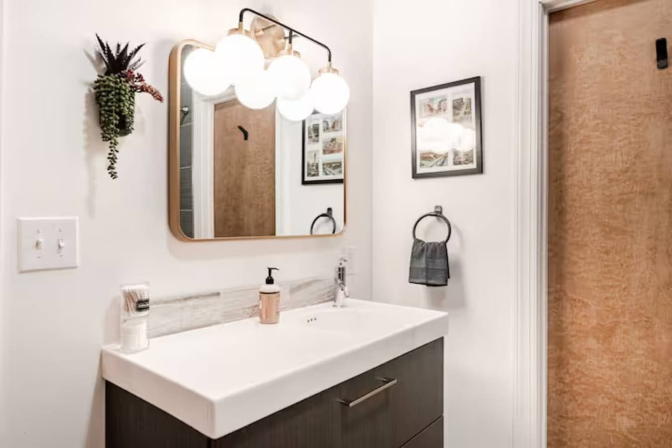 Bathroom vanity with bright lighting and minimalist design.