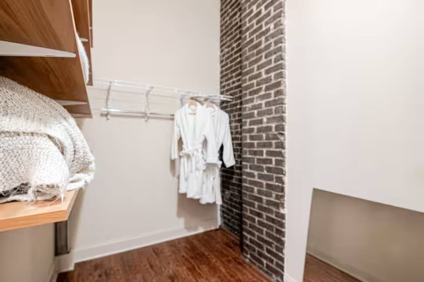 Open closet space with hanging storage and shelving.