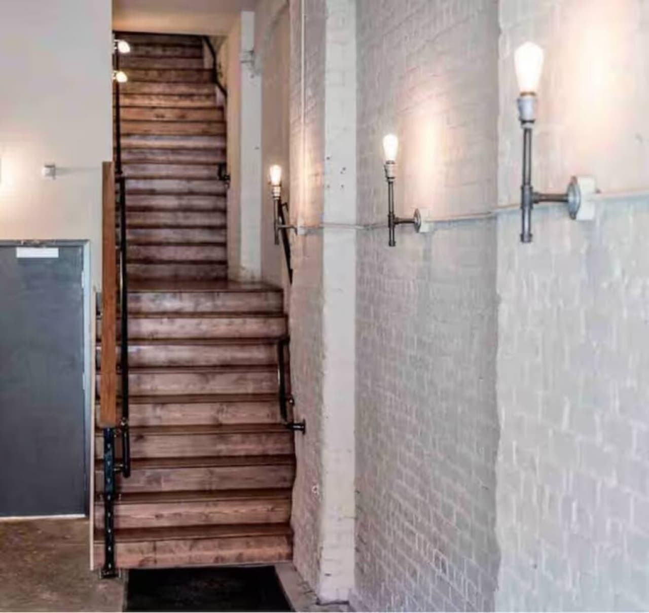 Stairway with industrial details and warm lighting.