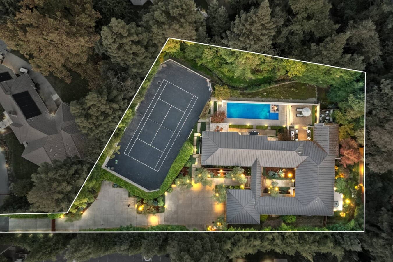 Aerial view showcasing the estate grounds, private tennis court, resort style pool, and exceptional outdoor amenities.