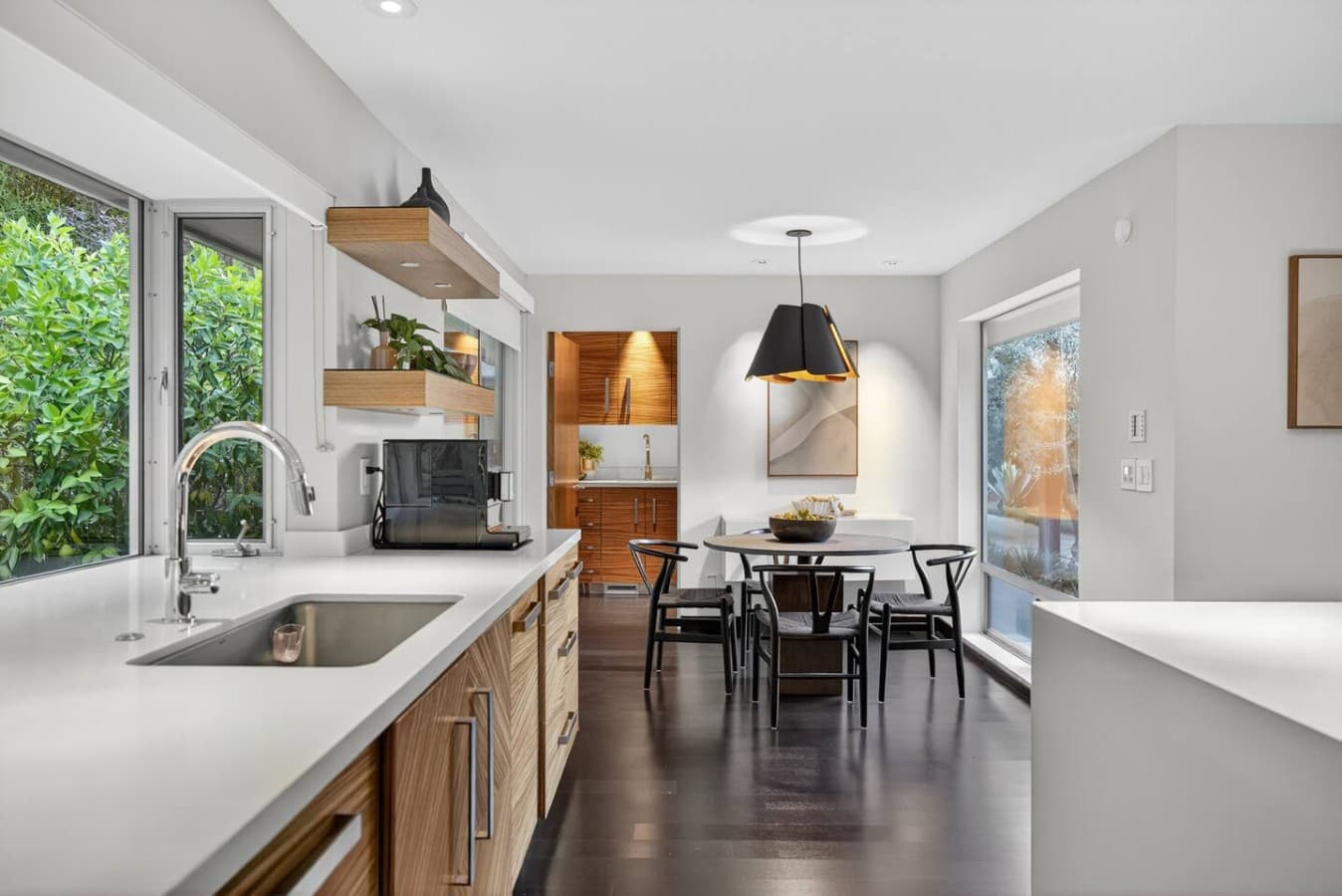 Bright breakfast nook surrounded by windows, creating the perfect spot for morning coffee and casual dining.