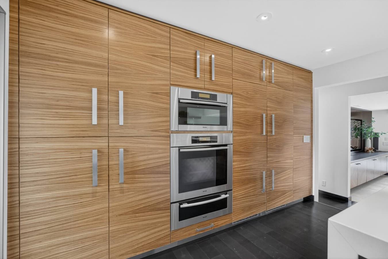 Built in double ovens and floor to ceiling cabinetry offer both style and exceptional functionality.