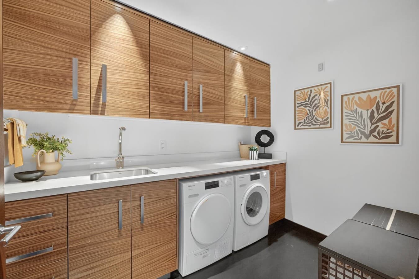 Dedicated laundry room with full size washer and dryer, ample storage, and generous counter space for added convenience.