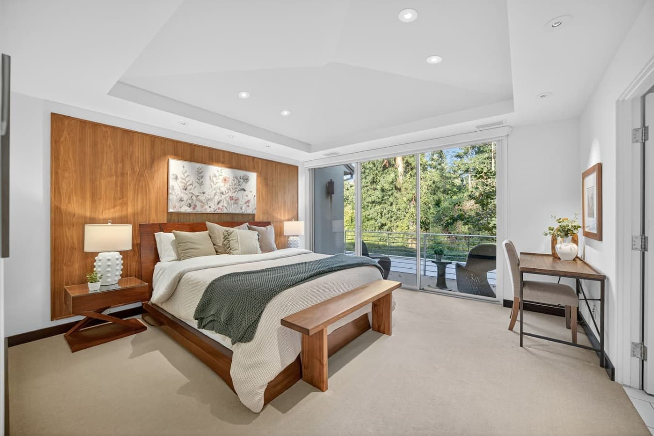 Beautifully appointed guest bedroom featuring custom wood accents, abundant natural light, and a serene atmosphere.
