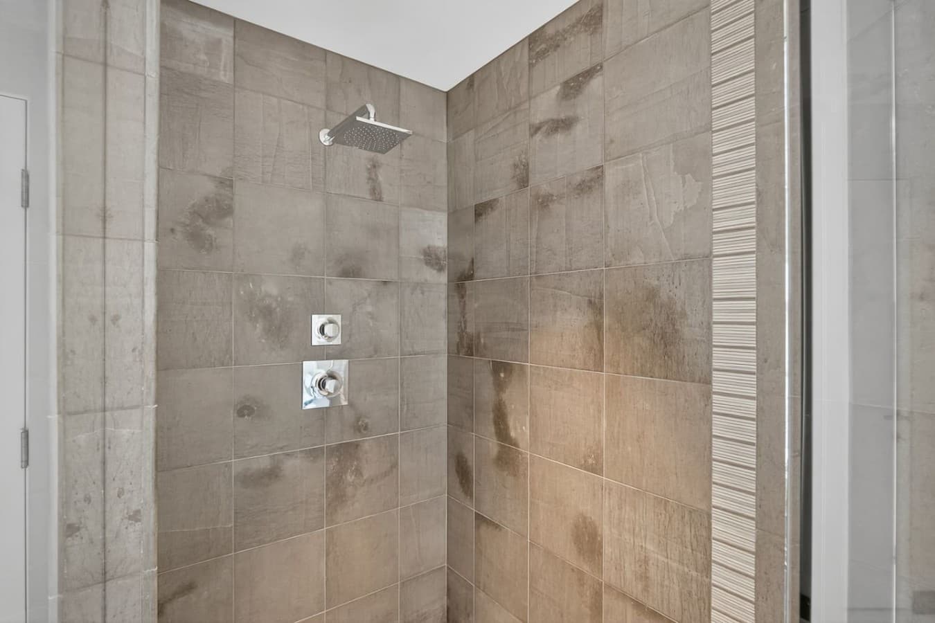 Oversized walk in shower with contemporary tilework and a relaxing spa like atmosphere.