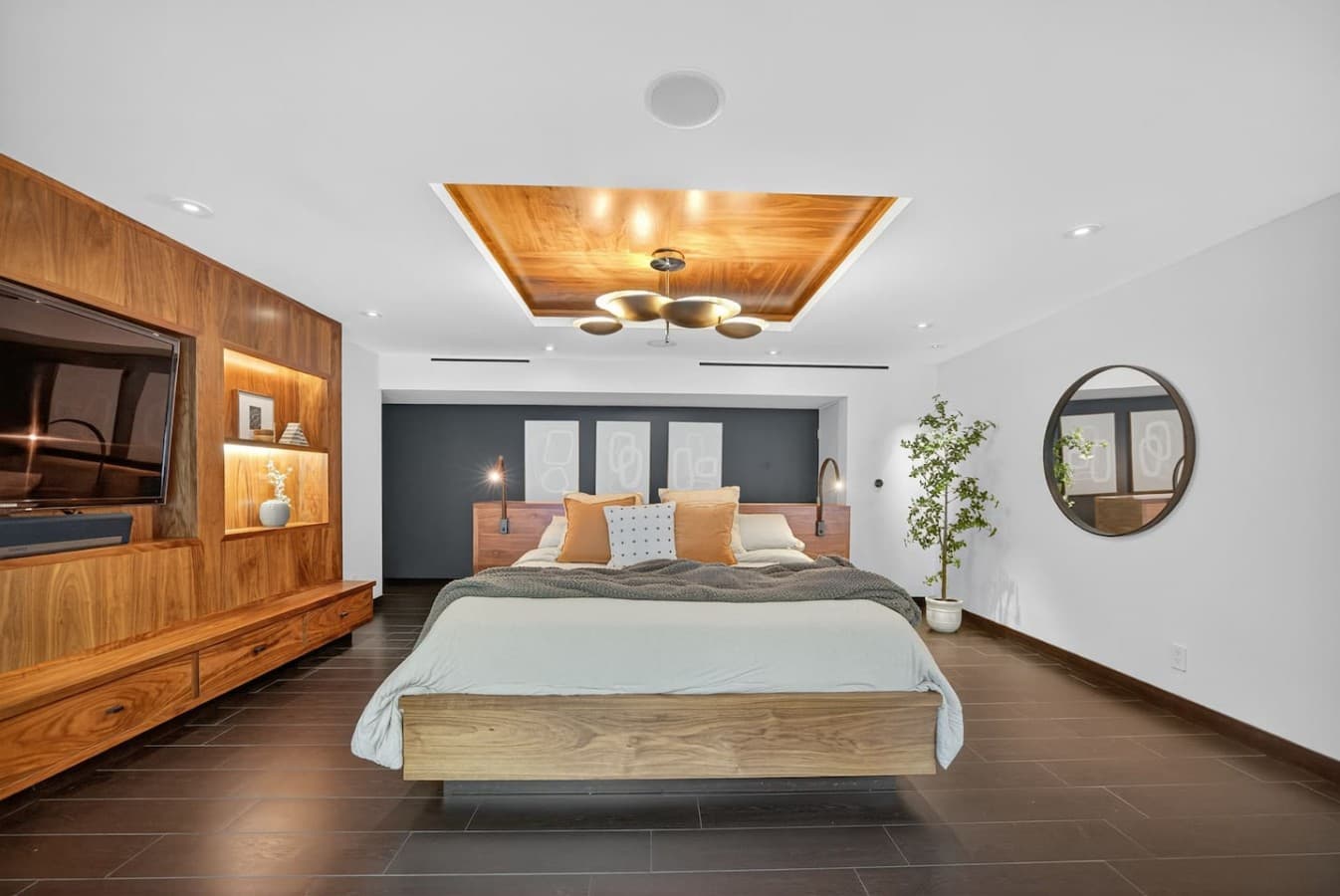 Expansive primary suite featuring custom wood accents, designer lighting, and a serene retreat like atmosphere.