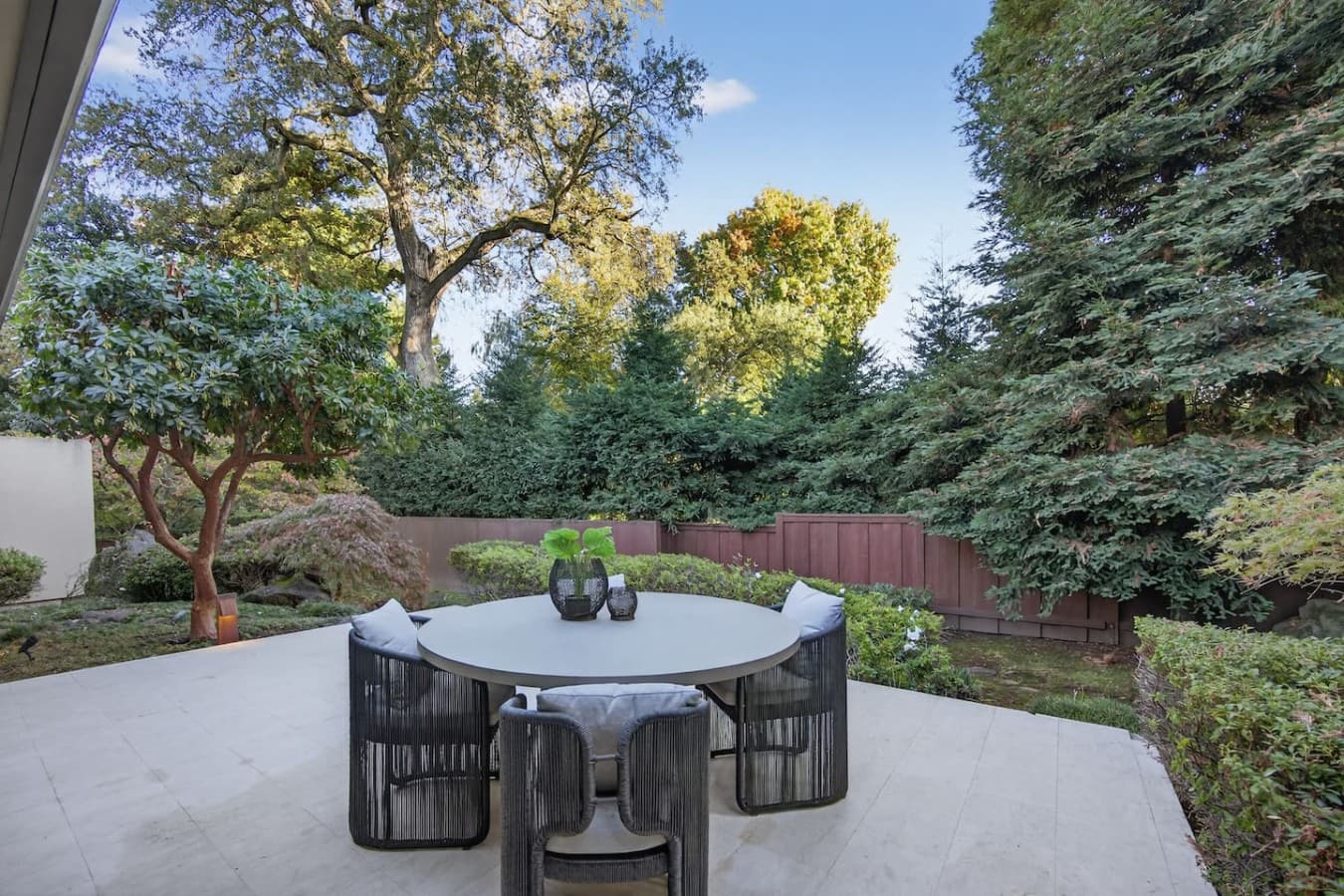 Tranquil terrace surrounded by lush greenery, ideal for morning coffee or evening gatherings.