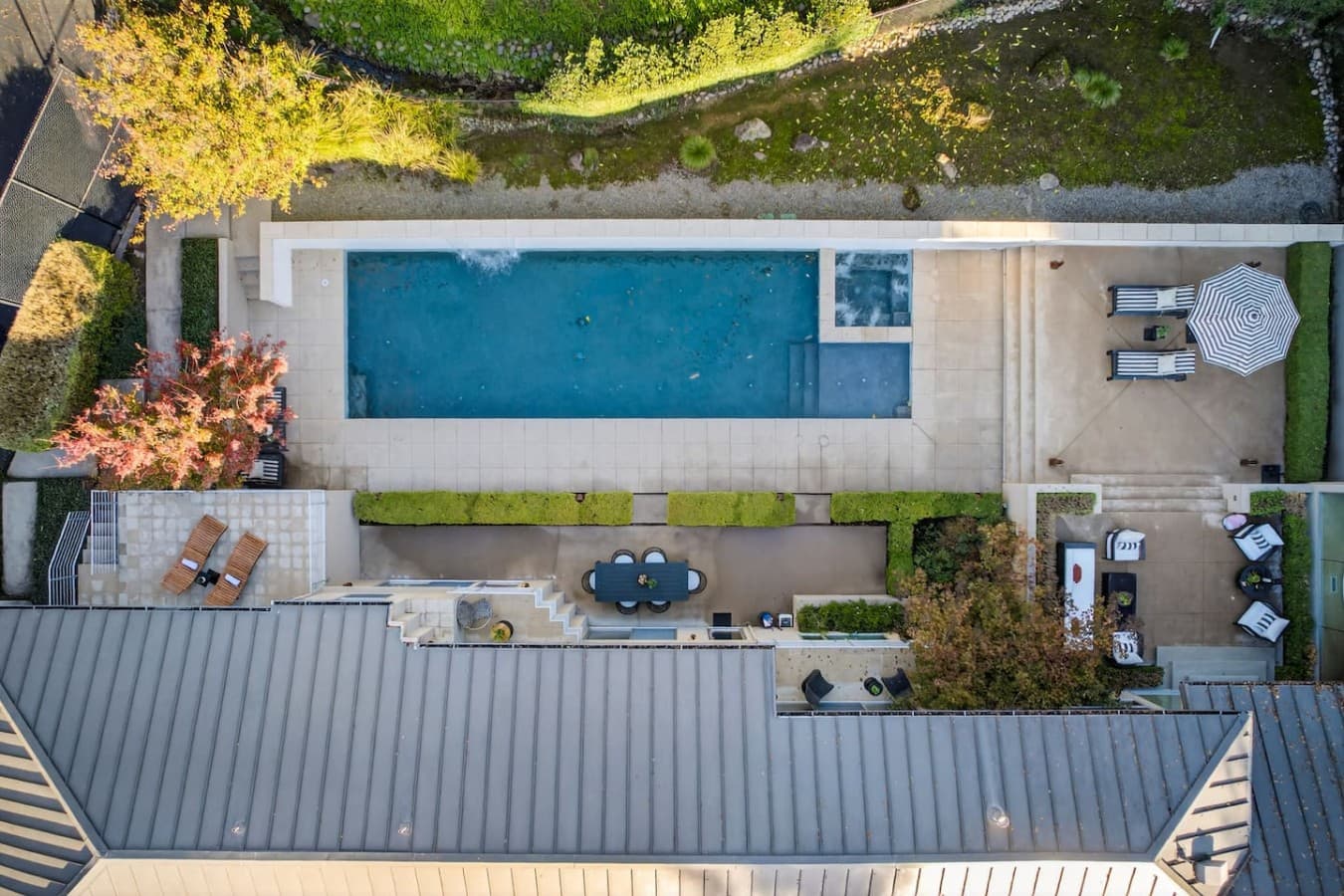 Aerial perspective highlighting the impressive pool, outdoor gathering spaces, and thoughtfully designed estate grounds.