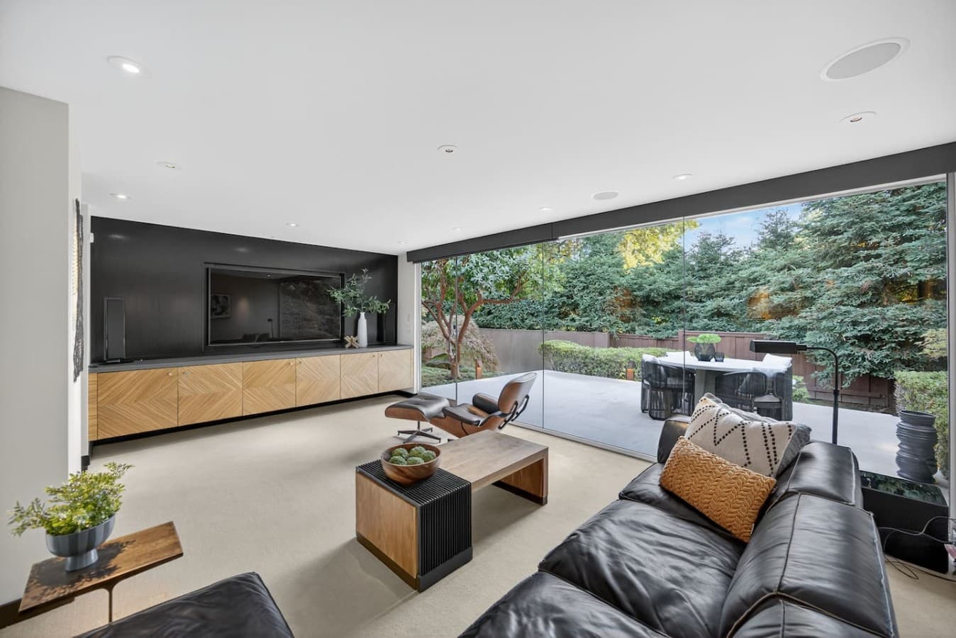 Bright indoor outdoor retreat perfect for relaxing, entertaining, and enjoying the surrounding greenery.