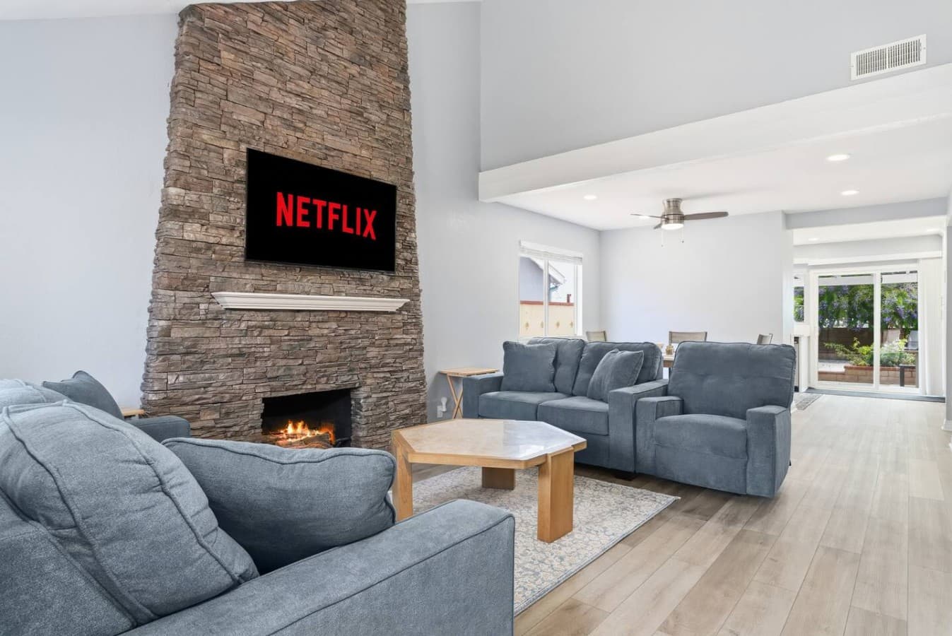 Cozy living room with fireplace and streaming ready entertainment.