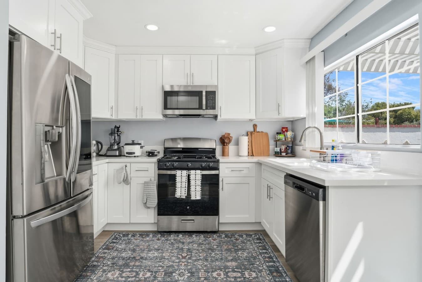 Modern fully equipped kitchen with stainless steel appliances.